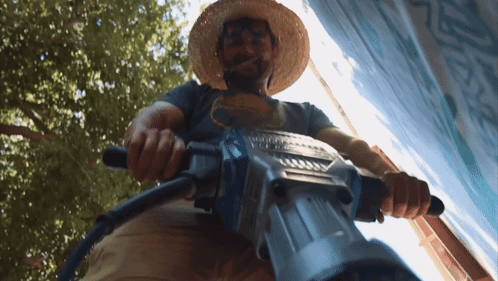 close-up-shot-of-man-using-jackhammer-o0d4l77cg3agxvn6.gif